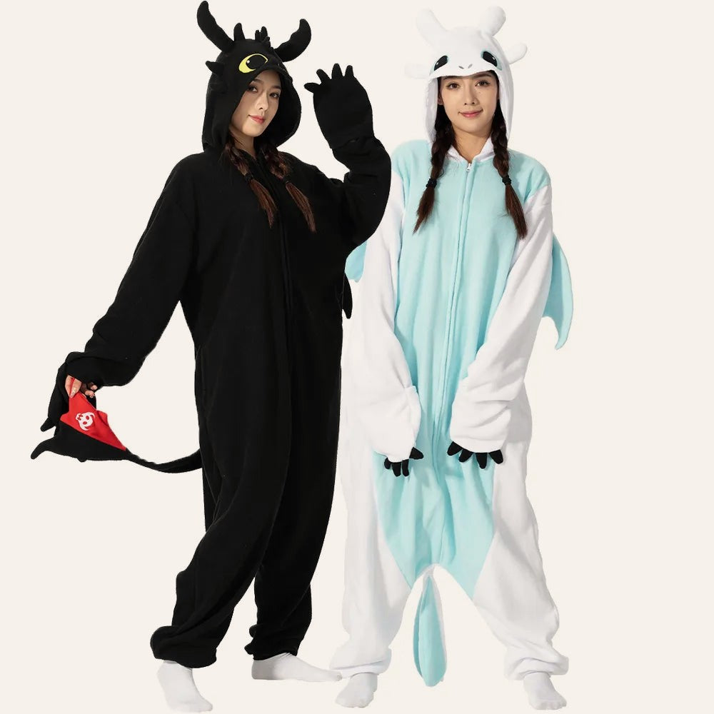 Two friends wearing The Comfy Dragon onesies in black and white